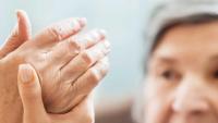 Doctor examining patient's hand